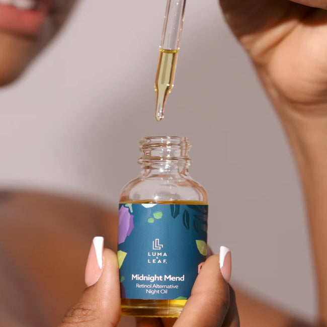 Using a dropper to extract oil from a bottle