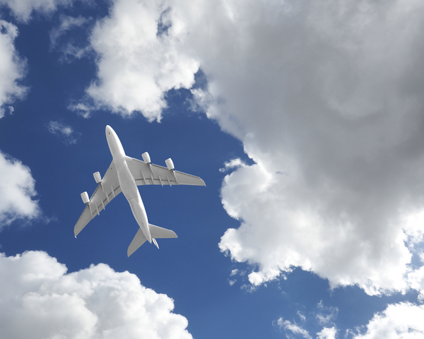 Photo of a plane in the clouds.