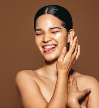 Woman smoothing moisturizer onto dry, dull-looking skin