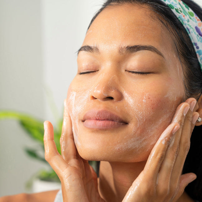 Woman applying a skincare routine to her face