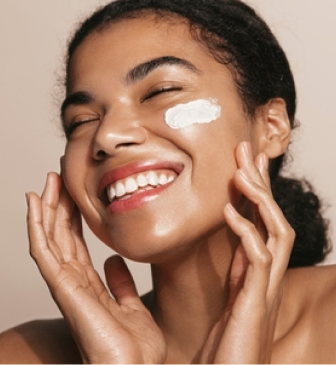 Woman applying a soothing cream to sensitive skin