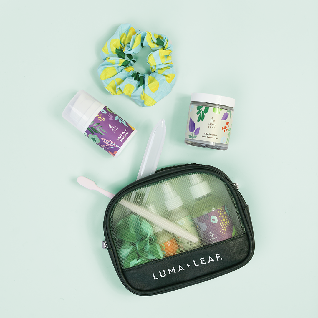 On the Glow cosmetic bag held by a model