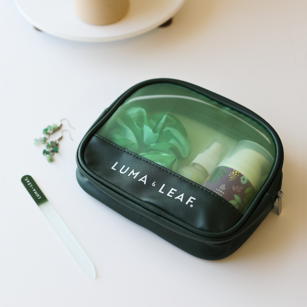 On the Glow makeup bag with skincare products inside