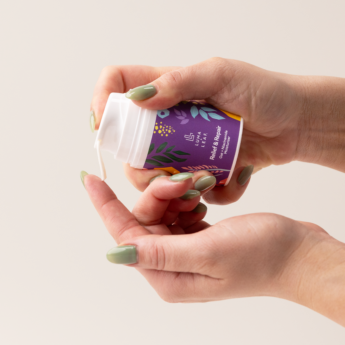 Relief and Repair natural face moisturizer held in hand to show size
