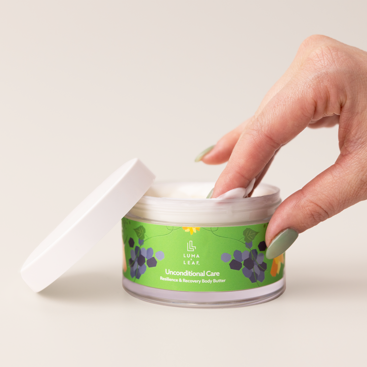 Unconditional Care body butter held in hand to show size