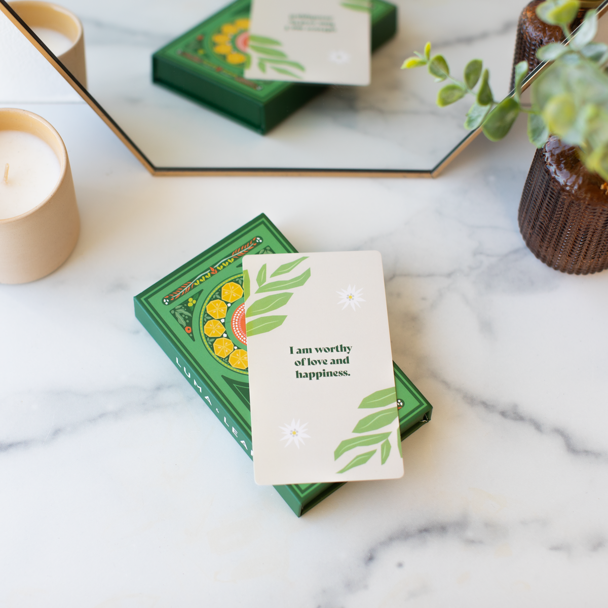 Luma & Leaf affirmation cards held in hand